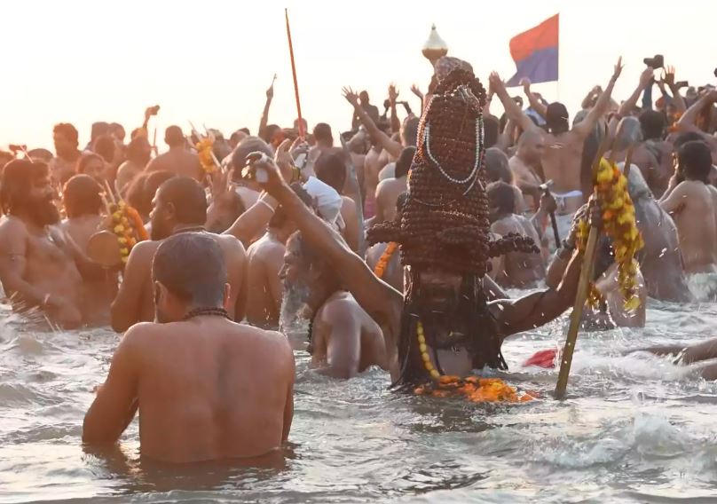 sadhus at mahakumbh taking holy bath at sangam